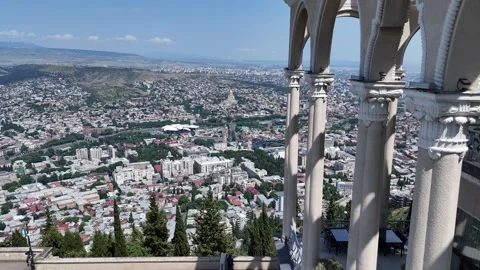 Dynamic cityscape view from elegant balcony arches Video stock 322600027