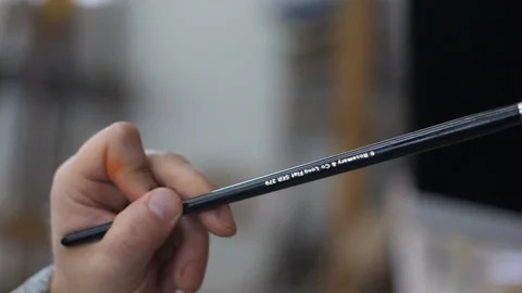 Dynamic close up of artists hand and oil paint brush in slow motion Stockbeeldmateriaal 104274752