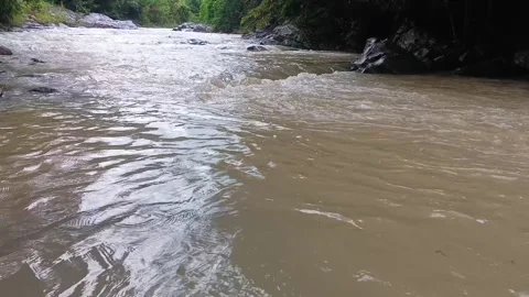 Dynamic Close-up of Brown Muddy River Water Surging Downstream. Stock Footage 321933023