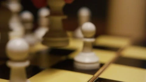 Dynamic Close-Up of Chess Pieces in Play on Chessboard Stockbeeldmateriaal 331375928