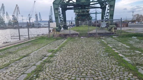 Dynamic close-up drone view of industrial port crane against sky Stock Footage 322019726