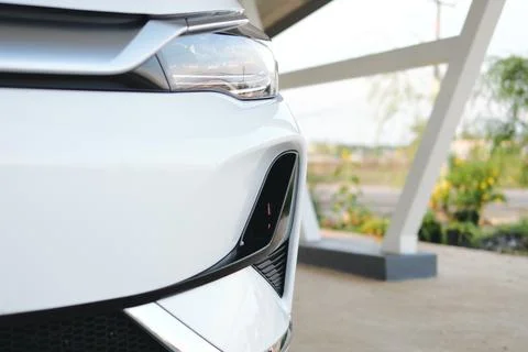 Dynamic close-up of a modern car's front design urban setting daylight arti.. Stock Photos