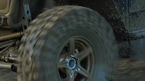 A dynamic close-up of a muddy UTV wheel spinning fast during Vídeo Stock 344876460
