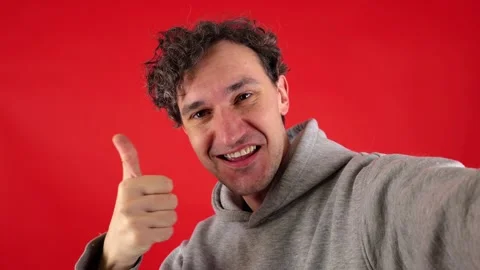 A dynamic close up portrait of a young man taking a selfie. Vidéo 304748717