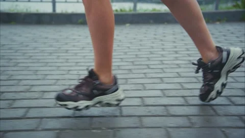 Dynamic close-up of a runners legs in motion showcasing athletic shoes on a Stock Footage 313855167