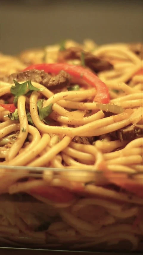 Dynamic close-up shot of a tray with delicious fried noodles Stock Footage 303722449