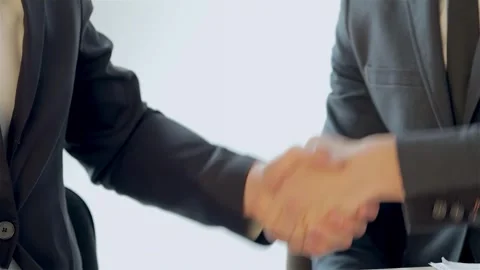 Dynamic close-up of two professionals shaking hands in a collaborative meeting Stock Footage 311813596