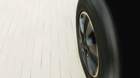 Dynamic close-up view with motion blur of the fast spinning tire on the left Stock Footage 221829839