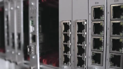 Dynamic closeup of network switch ports in server room highlighting connectivity Stock Footage 314426302