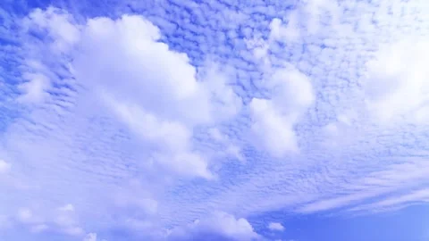 Dynamic Cloud Movement Across a Clear Blue Sky – Timelapse Stock Footage 336491057