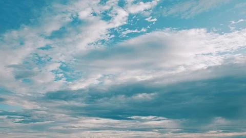 The Dynamic Cloud Patterns that Form Above a Calm Horizon are Truly Captivating Stock Photos