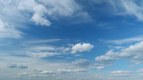 Dynamic cloud time-lapse from calm blue skies to cloudy. Puffy fluffy white Stock Photos