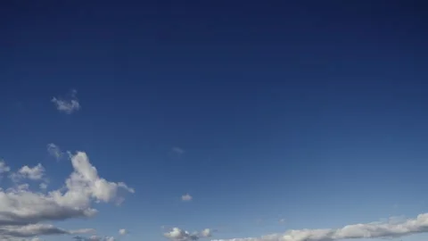 Dynamic clouds dance across a deep blue sky in this high quality timelapse Video stock 330376691