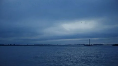 Dynamic clouds move fast over water and lighthouse Video stock 67880617