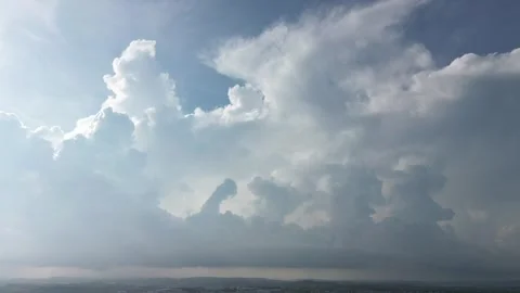 Dynamic cloudscapes unfolding over a distant urban sprawl. Stock Footage 319608186