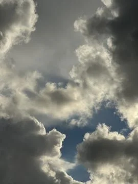 Dynamic Cloudy Sky with Bright Sunlit and Dark Storm Clouds Stock Photos