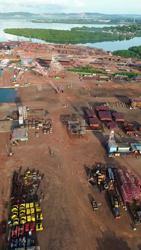 Dynamic coastal industrial hub development with extensive machinery and raw.. Video stock 337282564