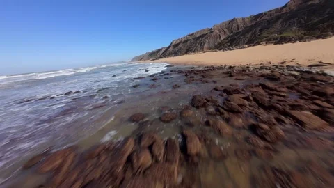 Dynamic coastal scene with crashing waves and rocky shore Video stock 346077602