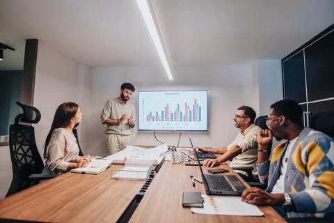 Dynamic Collaboration: Multiracial Team Brainstorming Sales Strategy in Modern Stock Photos