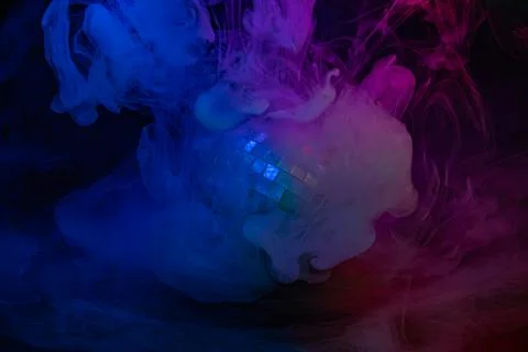 A dynamic, colorful explosion of bubbles or droplets contrasted against a whi Foto stock