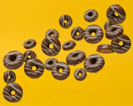 Dynamic composition with chocolate donuts in glaze that fall or float in th.. Stock Photos