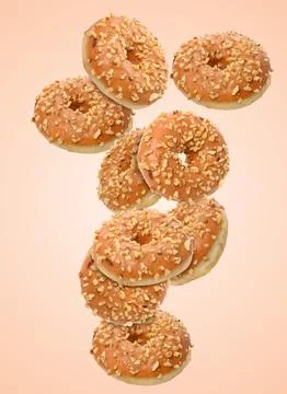 Dynamic composition of levitating caramel donuts with nut crumbs Stock Photos