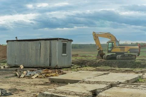 Dynamic Construction Site: Heavy Machinery in Action Under a Dramatic Sky. .. Stock Photos