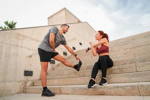 A Dynamic Couple Engaging in Stretching Exercises Together Enjoying Their W.. Stock Photos