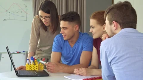 Dynamic creative team collaborates on laptop Stock Footage 311991960