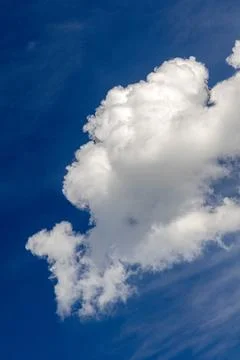 Dynamic cumulus cloud formation against deep atmospheric blue sky background Фото