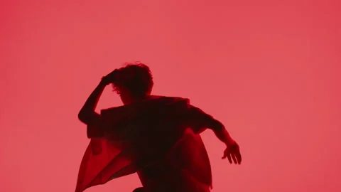 Dynamic Dance Against Red Backdrop Stock Footage 255537689