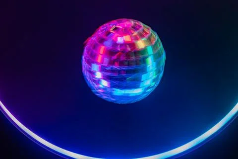 A dynamic disco ball against a dark backdrop, symbolizing vibrant energy an.. Stock Photos