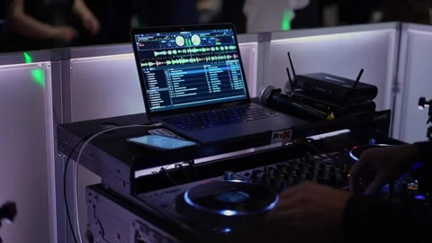 Dynamic DJ Setup with Laptop and Turntables in Nightclub Atmosphere Stock Footage 290933044