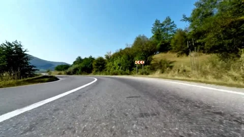 Dynamic Driving Shot on a Scenic Rural Road with Green Hills Stock-Footage 337684700