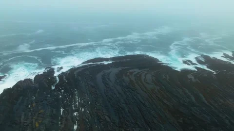 Dynamic drone aerial view of ocean waves smashing against a rocky coastline, cap Video stock 308928455