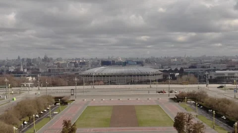 Dynamic drone ascent toward urban stadium Stock Footage 324546610