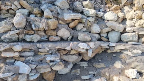 Dynamic drone close-up of natural stone wall in sunlight Stock Footage 322161129