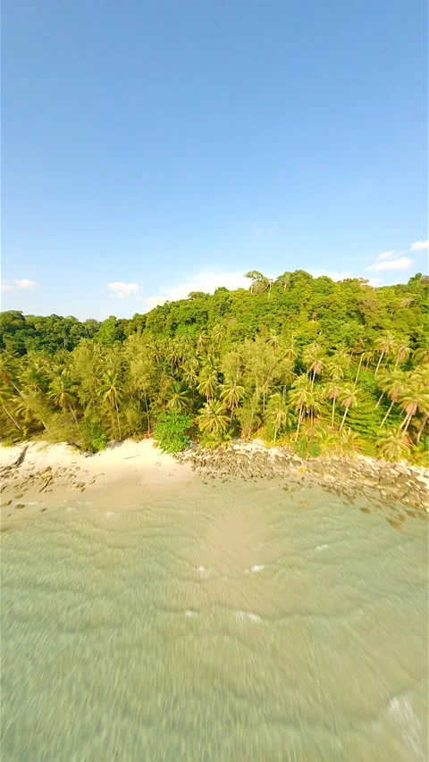 A dynamic drone flight over turquoise ocean, white beach and tropical rainforest Stock Footage 237930628