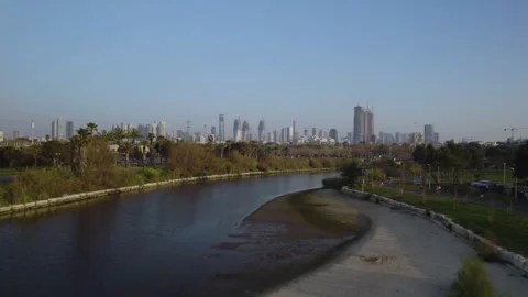 Dynamic drone flight over the Yarkon River, near the Reading Power Station in Stock Footage 306949714