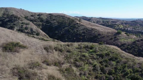 Dynamic drone flight through hills above Whittier California Video stock 121665299