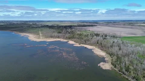 Dynamic Drone Follow Shot of a Winding River Shoreline from the Air Stock Footage 312237720