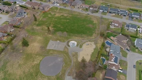 Dynamic drone footage tracking and rotating high above a baseball field Stock Footage 117438671