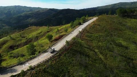 Dynamic drone orbiting along Daang Katutubo, emphasizing the road’s length Stock Footage 328347055