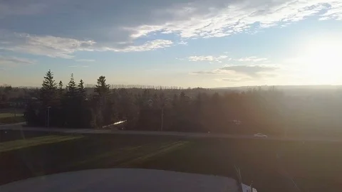 Dynamic drone shot above baseball diamonds near a road and subdivison at Stock Footage 103639060