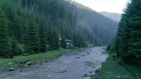 Dynamic drone shot of bus parked along mountain road Stock Footage 330075207
