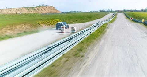 Dynamic drone shot of car passing by obstacles 스톡 동영상 89416324