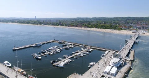 Dynamic drone shot of long pier with boatshore Stock Footage 89903820