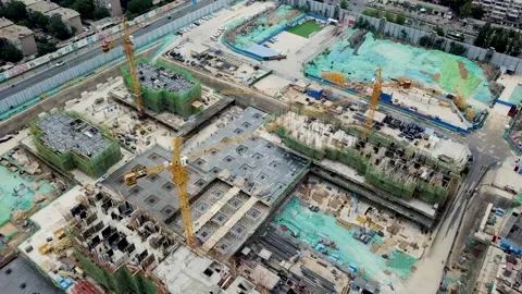Dynamic Drone Shots of Cranes Lifting Steel Beams at Dawn Stock Footage 304314046