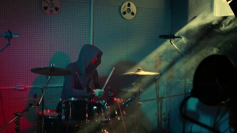 Dynamic Drumming in a Neon-Lit Recording Studio Stockbeeldmateriaal 312346001