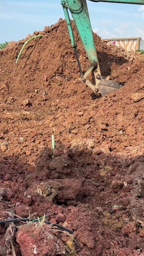 Dynamic earthmoving: Excavator precisely manipulates soil for ground prepar.. Stock Footage 337286372